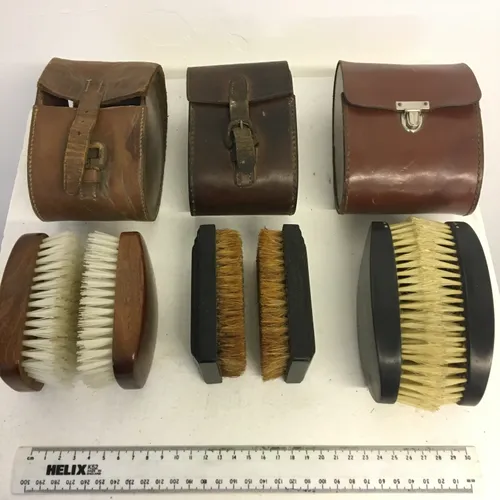 Various Pairs of Shoe Polishing Brushes with Brown Leather Cases