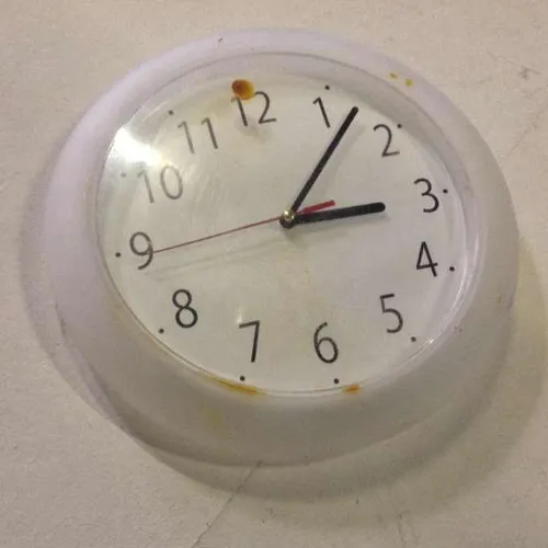 generic analogue plastic wall clock with white face and clear plastic rim