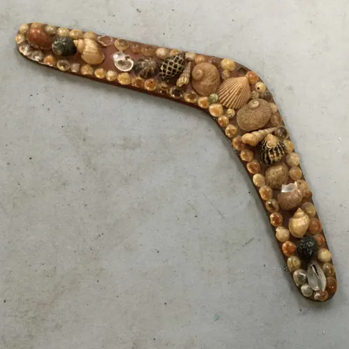 Boomerang covered in shells