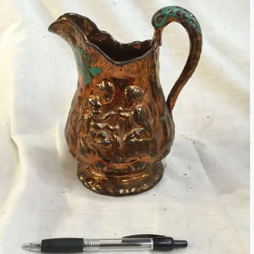 Copper coloured ceramic jug