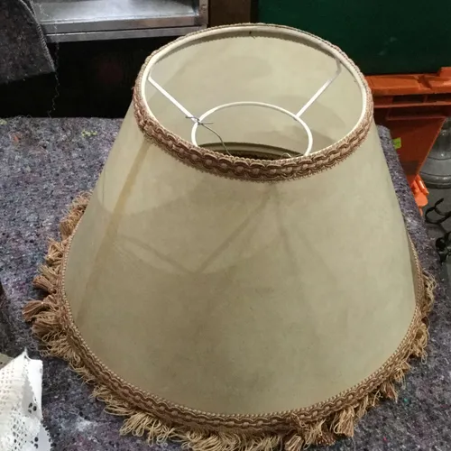Beige lampshade with brown trim and tassels