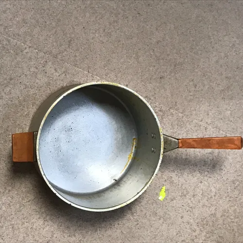 Metal pan with light wood handle