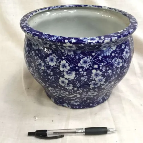 Royal blue plant pot with white flower and speckled details