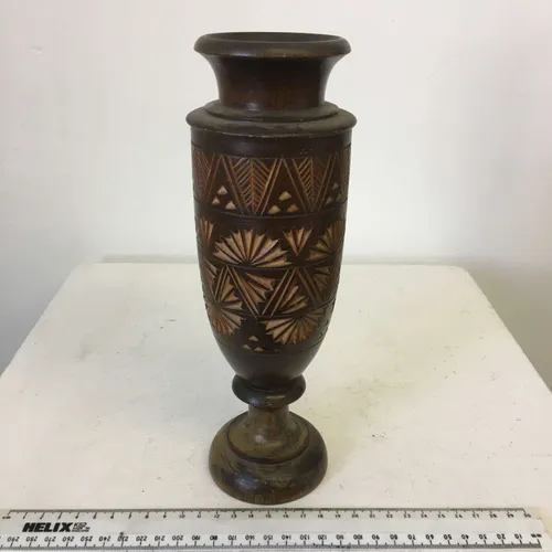 Dark wood bullet shaped candlestick with carved details