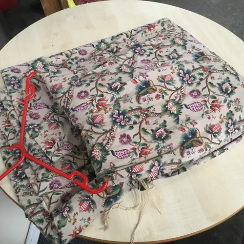 Grey drapes/curtains with colourful floral pattern 