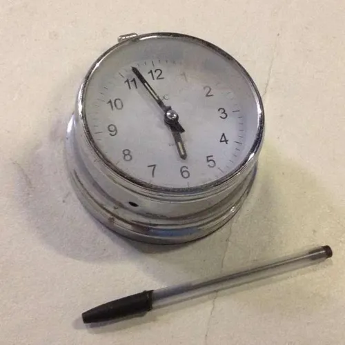 silver metal clock with white face