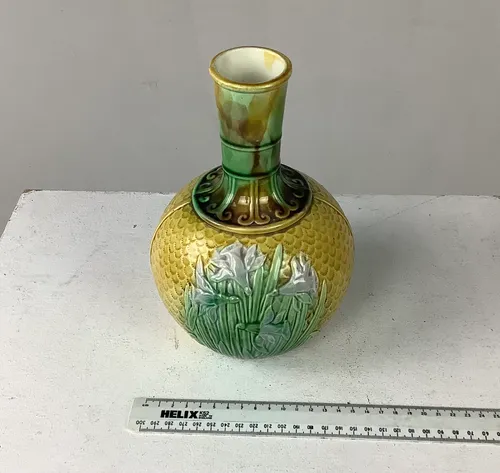 Yellow glazed ceramic vase with scale detail and white floral detail 