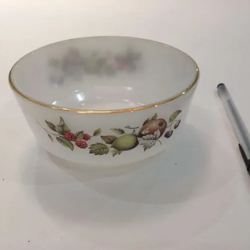 opaque bowl with fruit design and gold trim