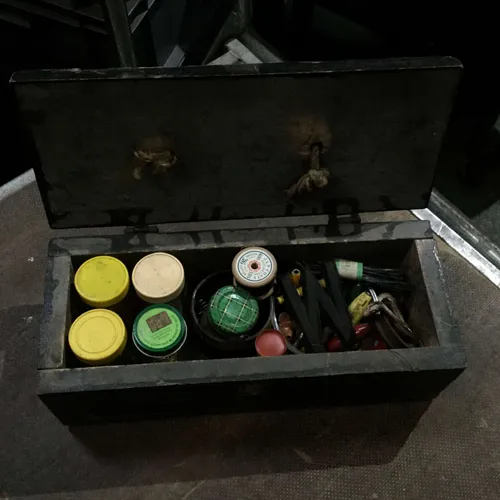 Black wood box with various pots