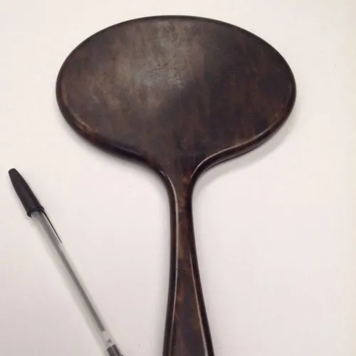 hand held brown mirror