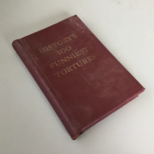 Period Maroon Hardback Ledger Book - History’s 100 Funniest Tortures