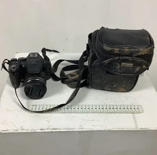 Black Worn Fujifilm Camera with Black Leather Case