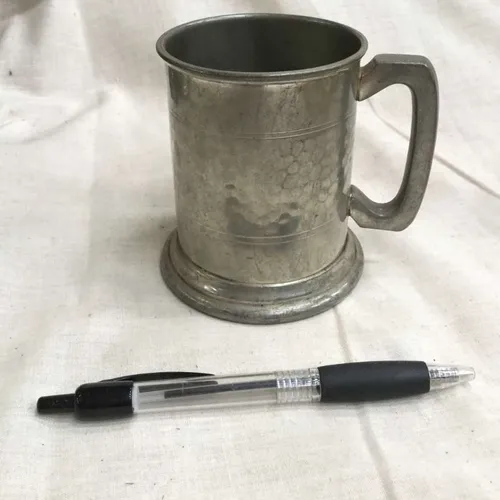 Short metal tankard with light indentations 