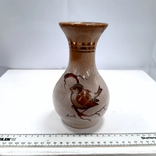 Small brown speckled ceramic vase with hand painted bird design 