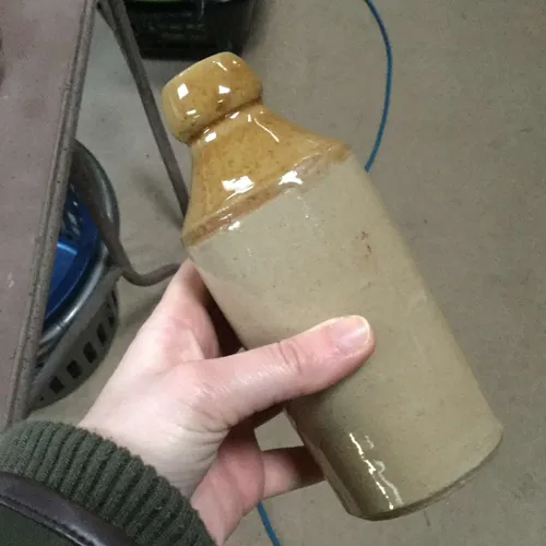 Stoneware bottle with sand coloured top