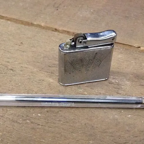 silver lighter with sun design
