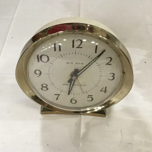 Small plastic white and gold clock