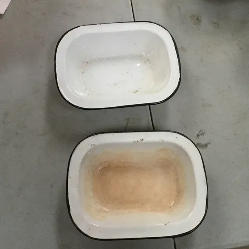 Medium size white enamel dish with black rim