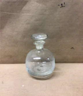 small round clear glass bottle with stopper 