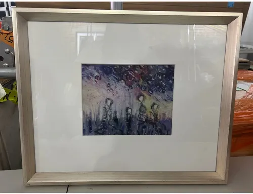 small abstract people shapes under the stairs silver frame 