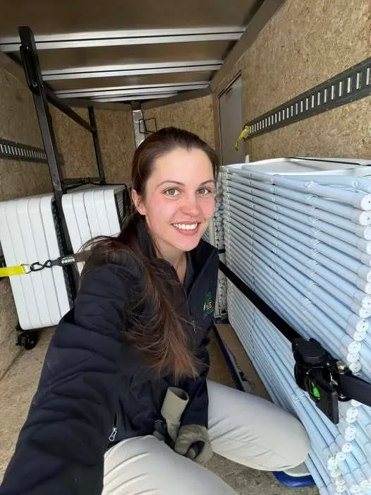 Becca, the owner and operator of Event Rent Maine takes a picture in the loaded trailer headed to a delivery of some tables and chairs.