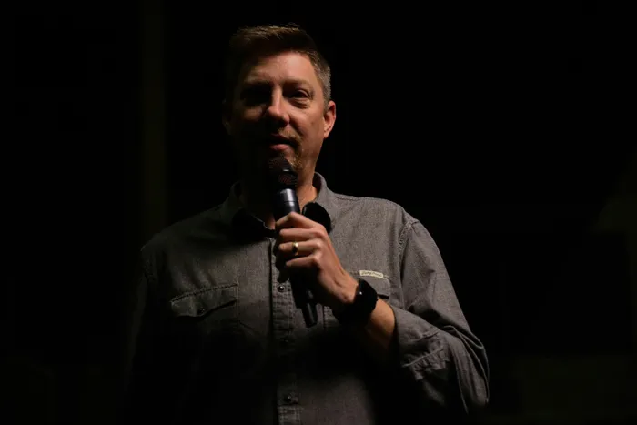 Presenter using a handheld microphone at a live function