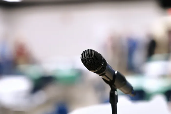 Microphone on a stand ready for speeches at an event venue.
