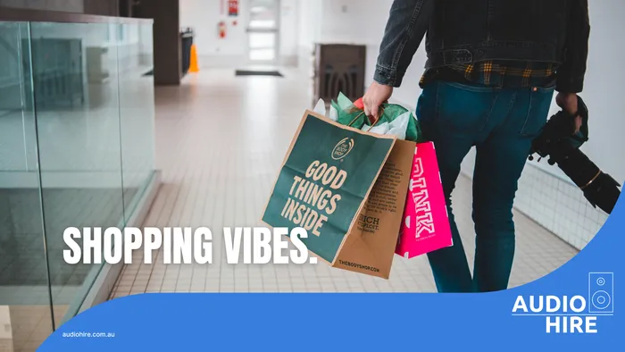 Man carries shopping bags. Adelaide Audio Hire.