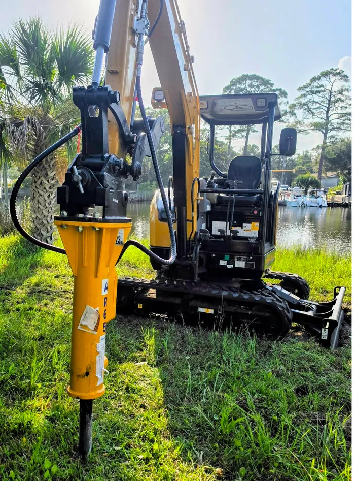 Mini excavator with hydraulic breaker attachment for concrete demolition in Santa Rosa Beach, Florida