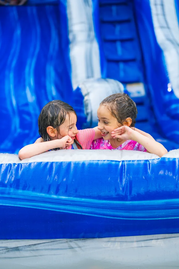 Kids having a blast on a Carnival Guy inflatable slide