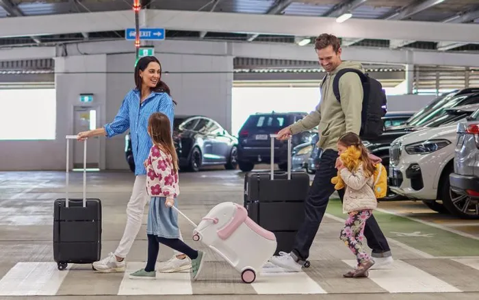 Family arriving into Auckland International Airport NZ with assistance using stroller